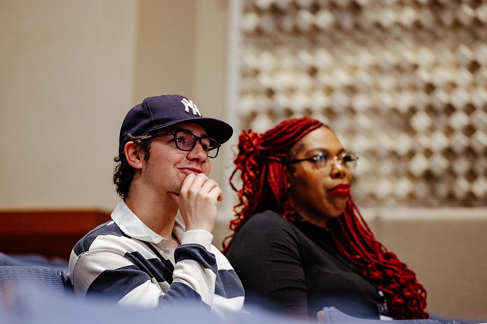 Student in a lecture hall looking engaged